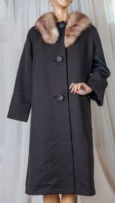 A lovely, classy coat. The fabric is a heavy textured deep rich brown, a wool blend. It has 3 very large bakelite buttons. The sleeve liners are gathered inside around the wrist to help keep out the chill. And the mink collar is removable. The mink collar is also fashioned who that it may be worn w/ other items. The coat as well as the mink are in very good shape. The lining is clean and intact. length 44, chest 46, arm length from shoulder seam 21.5, waist 46 I find it better to offer measureme Elegant Wool Outerwear With Faux Fur Lining, Elegant Brown Outerwear With Faux Fur Trim, Winter Outerwear With Covered Buttons In Solid Color, Winter Solid Outerwear With Covered Buttons, Elegant Brown Fur Coat For Cold Weather, Elegant Brown Long Fur Coat, Elegant Long Brown Fur Coat, Elegant Solid Color Fur Coat For Winter, Elegant Winter Fur Coat