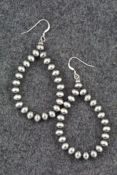 These sterling silver bead earrings were made by Navajo silversmith Louise Joe.Length: 2 5/8"Width: 1 1/4"Bead Size: 3/16"Free shipping on all orders! We ship with USPS and always include tracking. All orders ship within a day of payment.Returns are accepted up to 30 days after you receive your order. Just send us a message. Our shop offers cash back or store credit. The item must be returned in new condition. Southwestern Sterling Silver Beaded Jewelry, Sterling Silver Teardrop Earrings With Silver Beads, Southwestern Silver Jewelry With Spacer Beads, Southwestern Style Silver Jewelry With Polished Beads, Artisan Silver Earrings With Silver Beads, Silver Bead Artisan Earrings, Traditional Silver Teardrop Beaded Earrings, Silver Teardrop Beaded Earrings In Sterling Silver, Artisan Sterling Silver Beaded Earrings