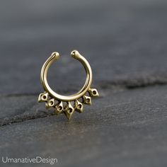 Unique and beautiful septum ring for non pierced nose. Tribal, ethnic, delicate design. Material: Gold Plated : Also available in sterling silver and brass, you can choose the material. Inner diameter: 8 mm - 0.31 Inc : The size can be adjusted according to your nose because it's a clip-on. Material: *Available in brass, sterling silver 925 and gold plated, you can choose the material. Measures: Width 12 mm- 0.47 Inc / Length - 14 mm - 0.55 Inc Also available in for pierced nose : https://www.et Bohemian Gold Nose Rings Nickel Free, Bohemian Gold Nickel-free Nose Ring, Gold Bohemian Nickel-free Nose Ring, Handmade Bohemian Round Nose Rings, Adjustable Round Bohemian Nose Rings, Nickel-free Bohemian Septum Ring, Bohemian Nickel-free Septum Ring, Bohemian Adjustable Septum Ring As Gift, Bohemian Adjustable Septum Ring Gift