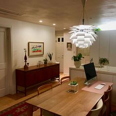 a dining room table with a laptop on it