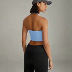 Introducing our Ribbed Halter Neck Sports Bra, a chic and supportive addition to your activewear collection. This women’s sports bra features a halter neck design that combines elegance with reliable support, perfect for both intense workouts and yoga sessions. Crafted from moisture-wicking fabric with mesh panels, it keeps you cool and dry, while the seamless, four-way stretch construction ensures freedom of movement. Removable padding allows for customizable support. Whether you're hitting the Sporty T-back Halter Top For Gym, Sporty T-back Halter Top For Sports, High Stretch Seamless Halter Top For Sports, Solid Crop Top With Light Support For Sports, Sporty Halter Neck Crop Top For Gym, Sporty Fitted Seamless Halter Top, Sporty Seamless Fitted Halter Top, Sporty Fitted Halter Top With Built-in Bra, High Stretch Seamless Sports Halter Top