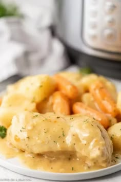 chicken and potatoes with gravy on a plate next to an instant pressure cooker