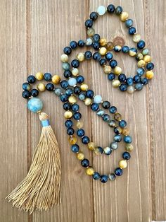 These Blue and Honey Tigers Eye beads are mixed throughout this mala. They are some of the most beautiful beads I have ever seen on one strand. This 108 mala necklace is hand-knotted on brown cord and has gorgeous aquamarine spacer beads located at the 27th and 54th position to add ease with counting your mantras. The Metal Jewelry Handmade, Mala Bead Necklace, Aquamarine Beads, Blue Tigers, Focal Points, Blue Tigers Eye, 108 Bead, Tiger Eye Beads, Eye Beads