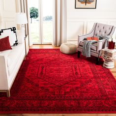 a living room with a red rug on the floor