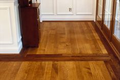 an empty room with hard wood floors and white walls