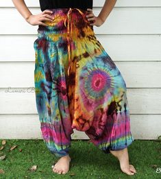 "💥One Size Fits Most Comfortable Low Cut Drop Crotch Tie Dye Harem Pants, Hippie Pants, Tie Dye Baggy Pants, Festival Harem Pants, Festival Clothing, Tye Dye Genie Pants, Tie Dye Comfy Pants 👉Fabric: Soft and Breathable Rayon 👉Smocked Elasticated Waist: 26\" up to 54\" 👉Hips up to: 60\" 👉Total Length: 39\" (Top to Bottom) 👉 Around elastic ankle 10\" 👉 Tie Dye Method 👉 One Size Fits M-XL or US 2-20 👉Extremely Comfortable 👉Boho/Hippie Theme, Beach Wear/Festival Going Pants Note: Due to t Summer Bohemian Baggy Pants, Baggy Multicolor Pants For Summer, Relaxed Fit Harem Pants For Summer Festivals, Hippie Relaxed Fit Harem Pants For Summer, Summer Hippie Relaxed Fit Harem Pants, Baggy Parachute Pants For Summer Festivals, Bohemian Baggy Parachute Pants For Summer, Summer Bohemian Baggy Parachute Pants, Bohemian Parachute Pants For Beach Summer