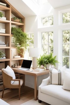 a laptop computer sitting on top of a wooden desk next to a white couch in a living room