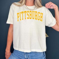 Vintage Pittsburgh Football cropped Tshirt Pittsburgh Shirt Football T-shirt retro Pittsburgh Tee Football Gift Comfort Color Crop Top -Please check Color and Size Charts before placing the order. You can find them in the listing's photos (Depending on what device you are viewing this listing colors may vary slightly). -Returns and exchanges are accepted only if there are defects "No Extra Costs" We create custom t-shirts with great designs for everyone's liking. If you don't find the size or co White Crew Neck Cropped Shirt With Letter Print, White Cropped Shirt With Letter Print, Crew Neck, White Letter Print Crew Neck Cropped Shirt, Retro Cotton Crop Top With Letter Print, Short Sleeve Cropped T-shirt With Letter Print For College, Cropped Short Sleeve T-shirt With Letter Print For College, Cropped Short Sleeve Letter Print T-shirt For College, White Retro Short Sleeve Cropped T-shirt, Cropped Letter Print T-shirt For College