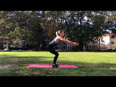 a woman is doing yoga in the park