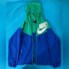 Boys Large Green And Blue Windbreaker Jacket - New But Tags Are Taken Off- Excellent (Mint) Condition And Unused Sporty School Outerwear With Pockets, Green School Outerwear With Pockets, Green Outerwear With Pockets For School, Nike Sporty Windbreaker, Blue Nike Windbreaker With Pockets, Blue Spring Track Jacket For Outdoor Activities, Blue Track Jacket For Spring Outdoor Activities, Nike Green Hooded Jacket For Sports, Nike Blue Windbreaker With Pockets