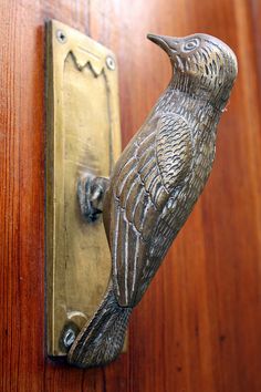 a door handle with a bird on it