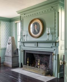 an old fashioned fireplace in a room with green walls and blue paint on the mantle