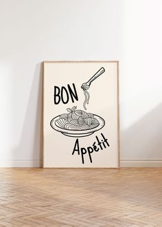 a poster with the words bon appetit on it in front of a white wall