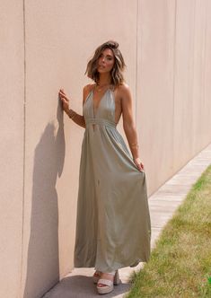 Unleash your inner beach babe in our Sydney Sundress! This olive halter neck sundress is the perfect addition to your summer wardrobe. Not only does it keep you cool in the sun, but its playful halter neck adds a touch of flirty flair. Bring on the sunshine (and compliments)! Fabric 97% polyester, 3% spandex Chic Halter Neck Maxi Dress For Day Out, Summer Backless Sundress For Parties, Chic Summer Backless Dress For Vacation, Summer Maxi Backless Dress For Day Out, Chic Halter Neck Top For Vacation, Summer Halter Neck Dress For Date Night, Summer Backless Dress For Beach, Summer Sundress With Tie Back For Summer Parties, Summer Sundress With Tie Back For Parties