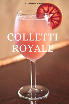 a wine glass with a grapefruit in it and the words colletti royale