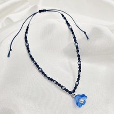 This bracelet is inspired by RM's album Indigo.  The bracelet closes with a sliding knot and is highly adjustable, tightening to 6.5 inches and extending to 11.5 inches. It is made with navy blue waxed thread, pearlescent white seed beads, and a blue flower charm with white pearl detail.  Please message me with any questions! Borahae! <3 Rm Indigo, Bts Rm, Sliding Knot, Acrylic Charms, Braided Bracelets, Flower Charm, Blue Flower, White Pearl, Pearl White