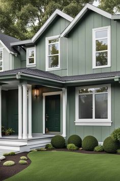 a green house with white trim and windows