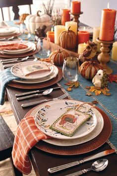 a table set for thanksgiving dinner with place settings