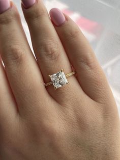 a woman's hand with a diamond ring on it