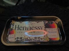 a metal tray with hennesy beer on it