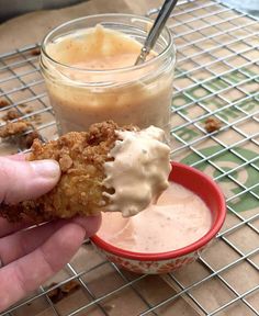 a person is dipping some food into a cup