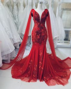 a red wedding dress on display in a store