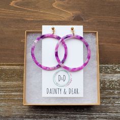 These colorful purple earrings carry a super fun boho vibe. They are cute and so comfortable to wear as they are very lightweight and of course hypoallergenic! Plus they are eco-friendly, as they are made from biodegradable material :) ♡ Materials info The circle pendants are cellulose acetate, while the gold-colored stainless steel ball posts and backs are hypoallergenic to keep sensitive skin happy.   ♡ Packaging info Each earring set will come beautifully packaged in a gift box, ready for gifting. They make an awesome gift for someone special, or to simply pamper yourself a bit :)   ♡ Measurements & other info Each earring measures about 2 inches long including the earring post. The pendant itself is about 1 3/4 inches wide. The placement and purple hues in the pendants may vary. Thus y Playful Purple Earrings For Gift, Playful Purple Earrings For Gifts, Fun Purple Earrings For Gift, Trendy Purple Plastic Jewelry, Trendy Purple Round Earrings, Trendy Hypoallergenic Purple Earrings, Purple Plastic Jewelry As Gift, Purple Plastic Jewelry Gift, Trendy Purple Earrings For Everyday Wear