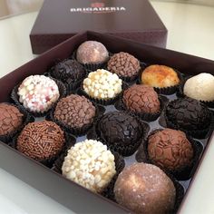 an assortment of chocolates in a box on a table