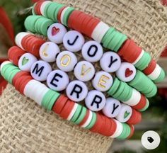 some type of bracelet that says love, merry on it and is decorated with candy