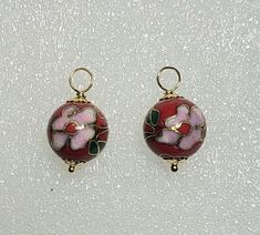 This listing is for ONE PAIR of Dangling Earring Charms featuring 12mm STUNNING High Quality Red Cloisonne with pink flowers. Each of these Cloisonne beads is hand made with excellent detail. ALL EARRING WIRES ARE SOLD SEPARATELY.  CHANGE THE WIRES AND YOU CHANGE THE LOOK. These are hand crafted in your choice of 14K gold filled wire or Solid Sterling Silver wire which gives them a two-tone look. They have 4.0mm openings to fit over your favorite hoops, studs or interchangeable lever back wires Red Round Jewelry With Flower Charm, Pink Round Earrings With Flower Charm, Flower Charm Round Bead Earrings For Gifts, Flower Charm Earrings With Round Beads As A Gift, Pink River, Interchangeable Earrings, Yellow Calcite, Earring Wires, Earring Charms