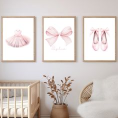 three pink ballet shoes are hanging on the wall next to a crib and baby's bed