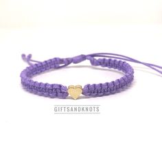 This bracelet is made of purple waterproof rope and a gold plated heart charm. Casual Gold Waxed Cord Jewelry, Trendy Purple Braided Bracelet For Gift, Trendy Purple Braided Bracelet Gift, Gold Heart Friendship Bracelets With Sliding Knot, Everyday Gold Friendship Bracelets With Heart Charm, Gold Waxed Cord Friendship Bracelets, Gold Waxed Cord Friendship Bracelet, Purple Adjustable Heart Bracelet For Valentine's Day, Adjustable Purple Heart Bracelet For Valentine's Day