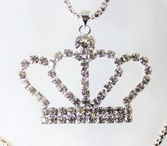 Gold or Silver Jewel Encrusted Crown Pendant, These crown necklaces are perfect for all royalty with all their rhinestones. They would make an exceptional gift for a fashionista. They are exquisite and would make an excellent charm or just as a collectible for the designer at heart. The are about 1.5 in x 2 in and they come with a 28" chain. Costume Jewelry With Rhinestones For Gifts, Metal Rhinestone Pendant Necklace, Party Pendant Rhinestone Necklace With Bling, Rhinestone Crystal Pendant Necklace With Bling, Party Rhinestone Pendant Necklace With Bling, Silver Crystal Jewelry With Crown Design, Rhinestone Bling Crystal Pendant Necklace, Costume Jewelry Crystal Pendant Rhinestone Necklace, Crystal Rhinestone Pendant Necklace Costume Jewelry