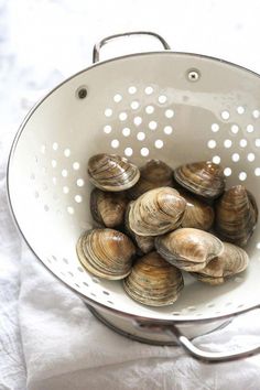 some clams in a colander on a table