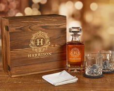 a wooden box with two glasses next to it and a bottle of harrison