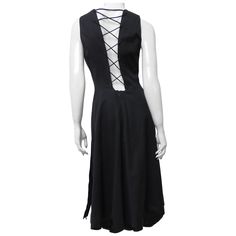 A fabulous black polished cotton dress from Hermes. It is sleeveless with a crew neckline, button front closure to the waist, hip pockets, and a cut out back with adjustable lacing crossing it. The flare skirt has functional button closures at the side seam hem to leave open to show more leg or button close. The dress is lined in the same fabric and has a center back zipper at the waist. Fit sizes Small, Medium. Marked French size 38. Bust 36" Waist 28" Hips Open Length 42" Sleeveless Cotton Evening Dress, Sleeveless Cotton Dress For Evening, Elegant Sleeveless Cotton Dress For Party, Sleeveless Cotton Midi Dress For Night Out, Elegant Cotton Sleeveless Dress For A Party, Silk Scarf Dress, White Silk Scarf, 1970s Dress, 1970s Dresses