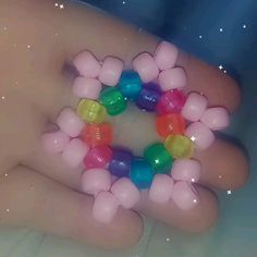 a person's hand holding a bunch of balloons in the shape of a circle