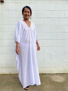 Unwind in absolute comfort with our semi sheer cotton gauze kaftan. This kaftan is perfect for the beach, pool, resort and laid-back time at home. Crafted from quality soft and breathable gauze cotton, it offers an airy fit that's ideal for lounging and cover up. Its relaxed design and easy slip-on style make it your go-to choice for outdoor cover up and relaxed nights at home. Beachy V-neck Cover-up With Relaxed Fit, Oversized White Cover-up For Loungewear, White V-neck Cover-up For Loungewear, White V-neck Loungewear Cover-up, Long White Cover-up For Loungewear, Breezy V-neck Beach Dress For Loungewear, Beach Linen Kaftan, Linen Kaftan For Beach, White Linen Beach Dress Cover-up