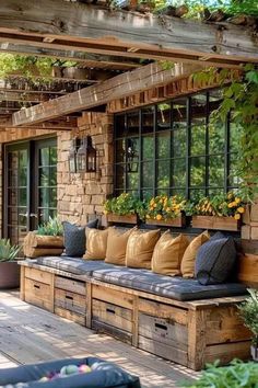 a wooden bench sitting on top of a wooden floor next to a window filled with potted plants