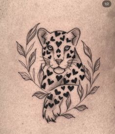 a black and white tattoo of a leopard with hearts