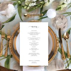 a place setting with gold plates and silverware