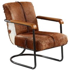 a brown and white chair sitting on top of a black metal frame with a cowhide seat