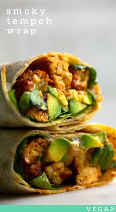 two wraps filled with meat and vegetables on top of each other