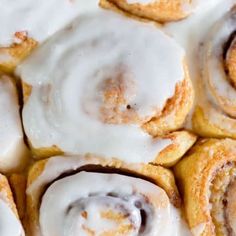 several cinnamon rolls with icing on top of them