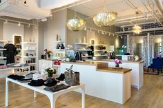 the inside of a shoe store with shoes on display and chandeliers hanging from the ceiling