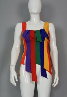 Features: - 100% Authentic MOSCHINO Cheap and Chic. - Carwash panel/ fringe novelty tank in rainbow colors. - Label reads: CHEAP and CHIC by MOSCHINO Made in Italy. - Size tag is missing (mannequin is size 36/38) please refer to the approximate measurements below. - Fabric Content: 79% Acetate, 21% Rayon. - Excellent vintage condition. Measurements taken laid flat, please double bust and waist: Shoulder: 12.99 inches (33 cm) Bust: 15.75 inches (40 cm) Waist: 14.17 inches (36 cm) Length: 29.52 in Rainbow Sleeveless Fitted Top, Rainbow Fitted Sleeveless Top, Fitted Rainbow Sleeveless Top, Spring Multicolor Color Block Tank Top, Multicolor Fitted Tops For Pride, Fitted Multicolor Tops For Pride, Multicolor Party Tank Top, Rainbow Fringe, Vintage Moschino