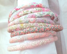 a stack of pink and green flowered hair ties