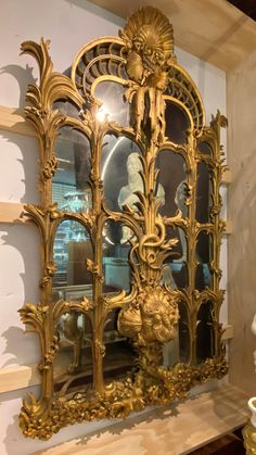 an ornate gold mirror on display in a room