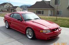 a red sports car parked in front of a house