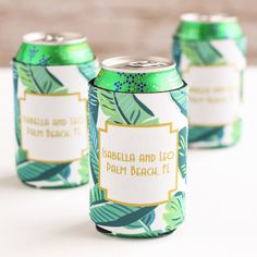 three green and white can coolers with labels on them